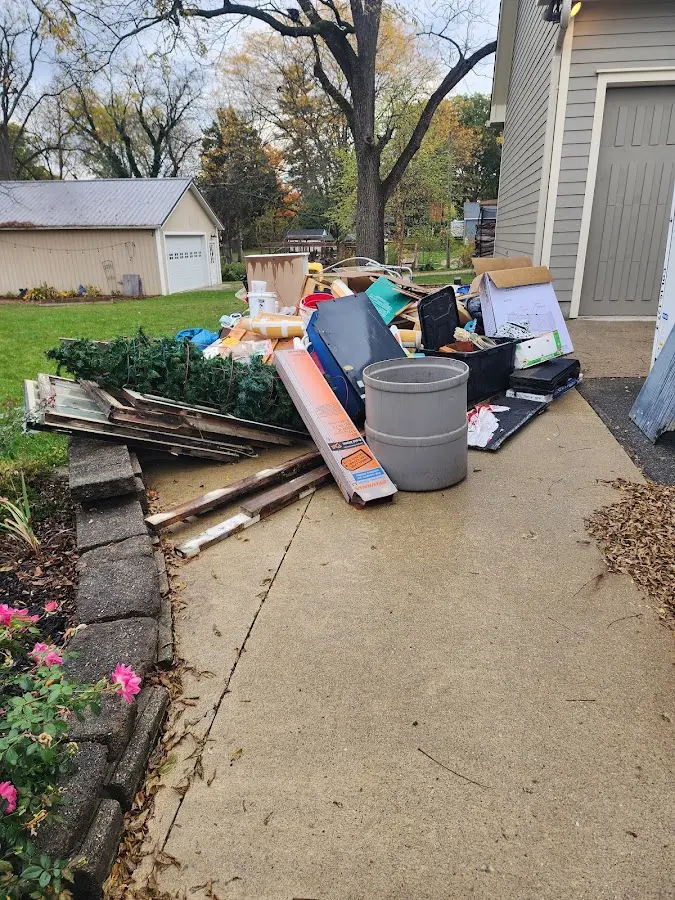 Dumpster being loaded with debris for Residential Dumpster Rental in Camden